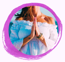 A woman holding her hands in namaste