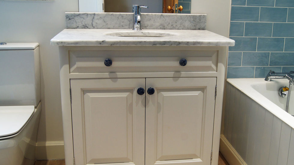 Classic bathroom vanity unit with marble top and undermount sink set in the bathroom