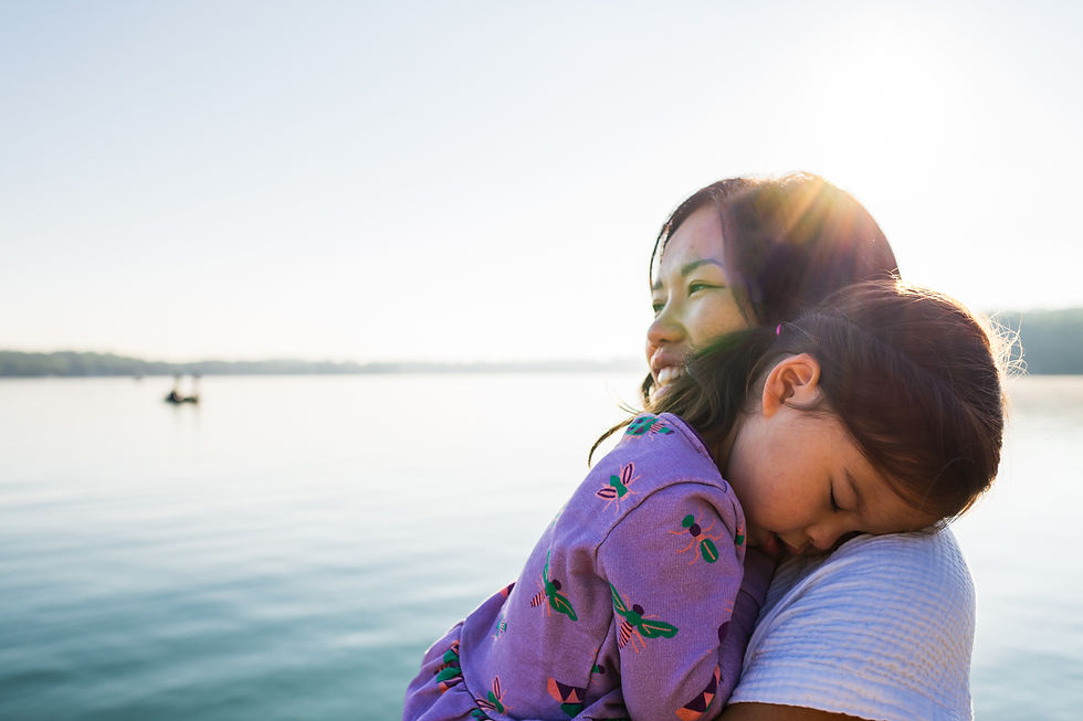 young girl resting head on mom's shoulder