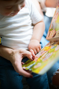 close-up of a mom reading to her young son during an at-home family photography session in charlottesville virginia