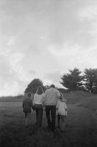A family walking together during a family photography session at Boar's Head Resort in Charlottesville, Virginia