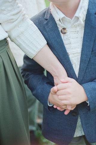 a son holding his mom's hand during a relaxed sunset family session with charlottesville family photographer Laura Richards