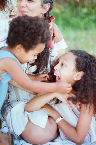 brother and sister playing excitedly during a motherhood photography session with charlottesville family photographer Laura Richards