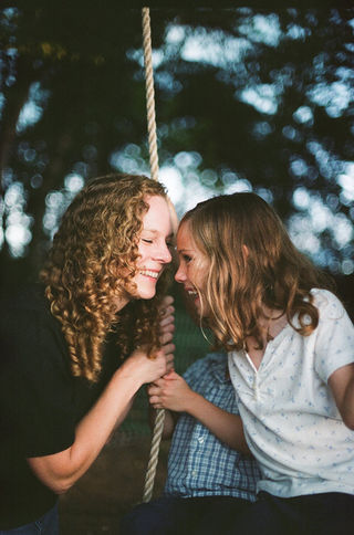 mom and daughter resting their foreheads on each other during a lifestyle family photo session in charlottesville virginia