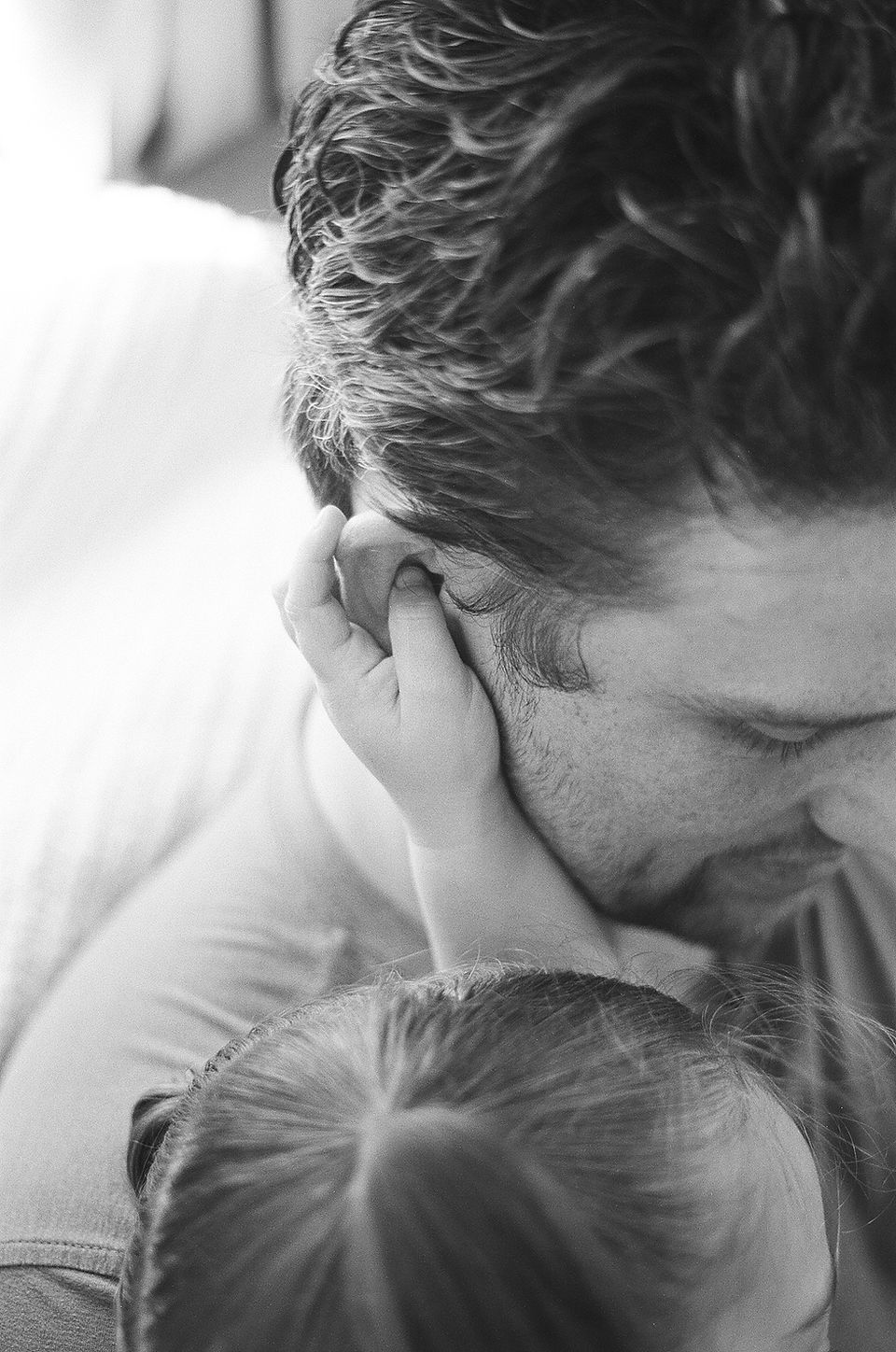 detail of a child holding onto her dad's ear during a lifestyle family photo session in charlottesville virginia by charlottesville family photography Laura Richards