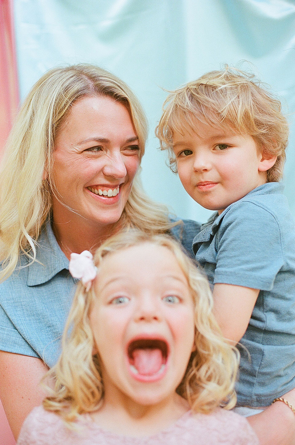 a mom smiles at her two happy kids during a family photography session with Charlottesville film photographer Laura Richards
