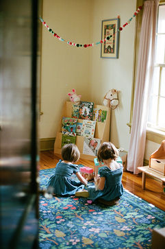 two little girls play in their bedroom during their relaxed family photography session
