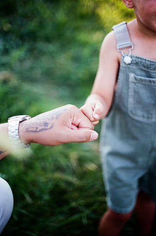 a dad and his son fist-bumping during a relaxed family session in charlottesville virginia