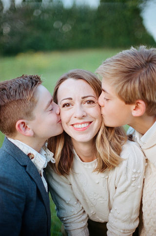 boys kissing their mom's cheeks during a family photographer session at boar's head resort with charlottesville photographer Laura Richards