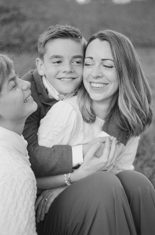 mom and sons enjoying a moment of laughter during a family photography session at Boar's Head Resort in Charlottesville, Virginia