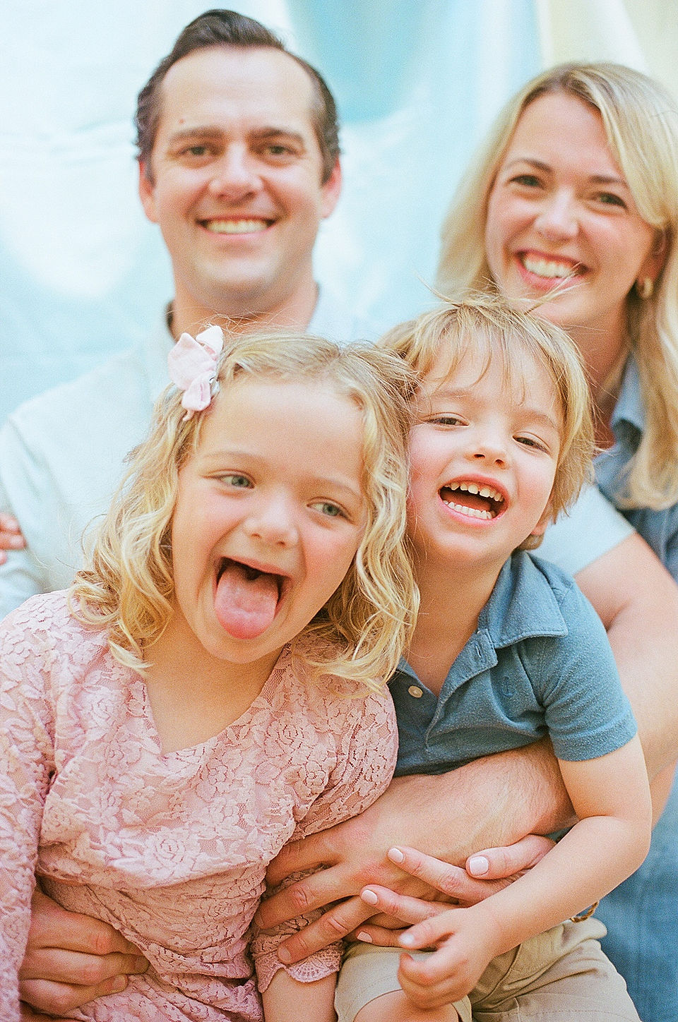 a family smiles happily and comfortably during an film-only portrait session with charlottesville family photographer Laura Richards