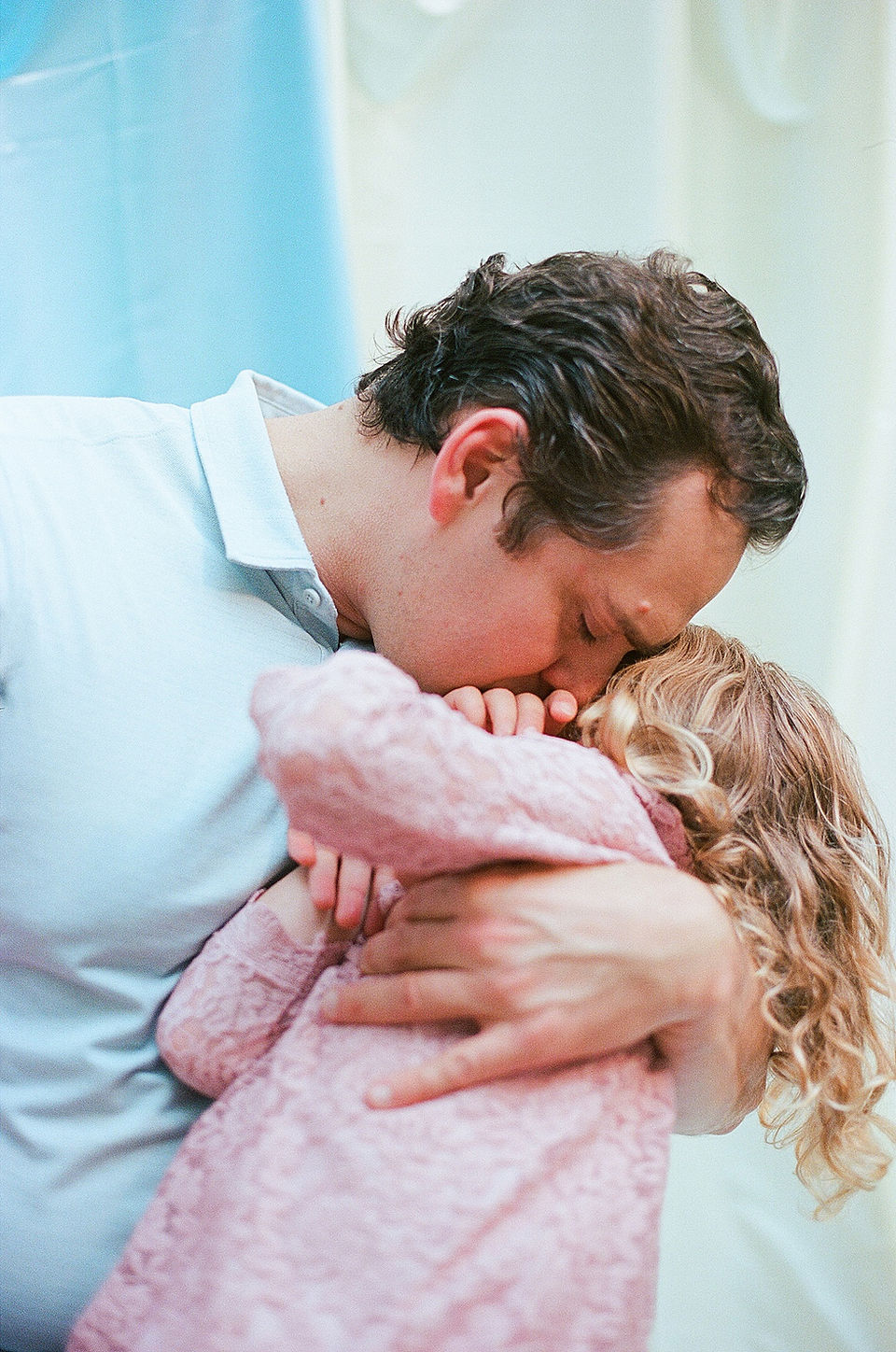 a dad tenderly snuggles into daughter during authentic family photos in charlottesville virginia