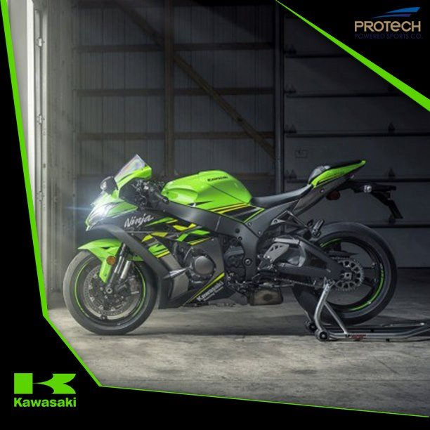 a green kawasaki ninja motorcycle is parked in a garage