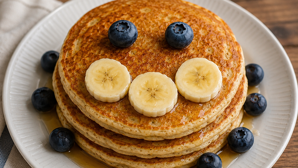 A stack of golden pancakes adorned with fresh banana slices and blueberries, drizzled with maple syrup, sits invitingly on a plate.
