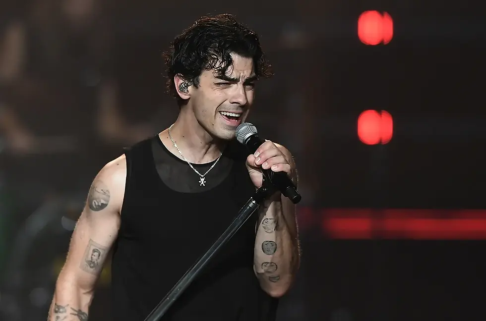 An American singer, songwriter, and actor who first became famous in the pop-rock band Jonas Brothers with his brothers Nick and Kevin.