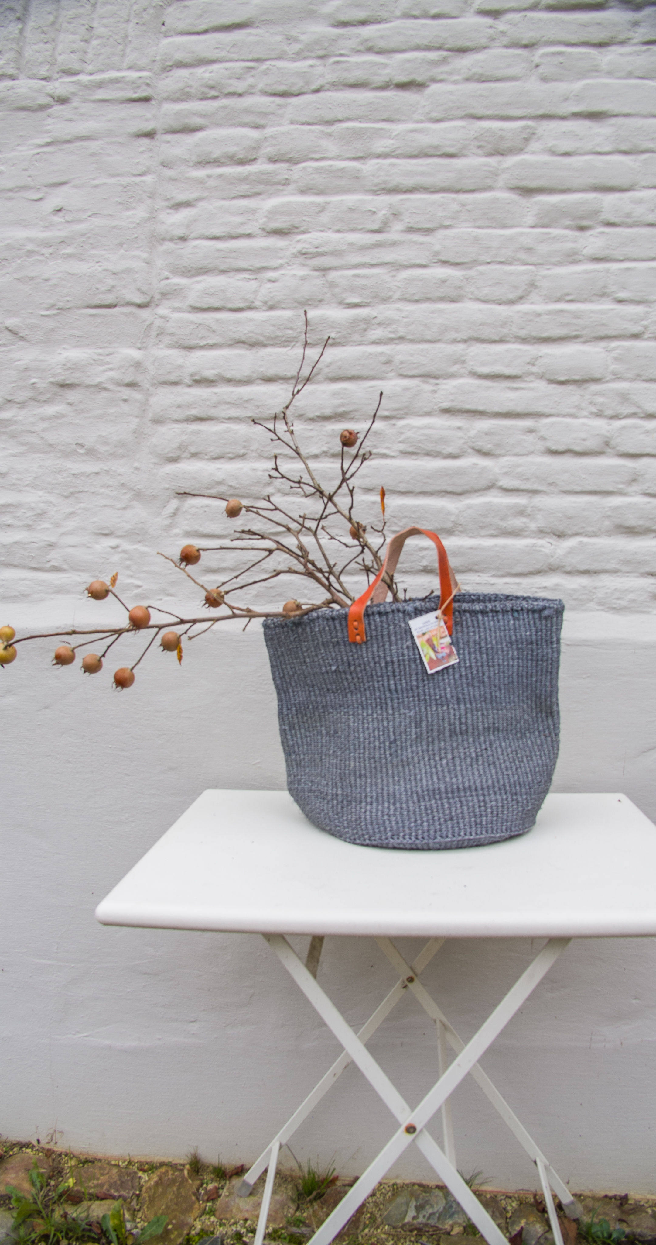 NUNGI; Warm grey  woven storage/planter basket/shopper basket with short leather