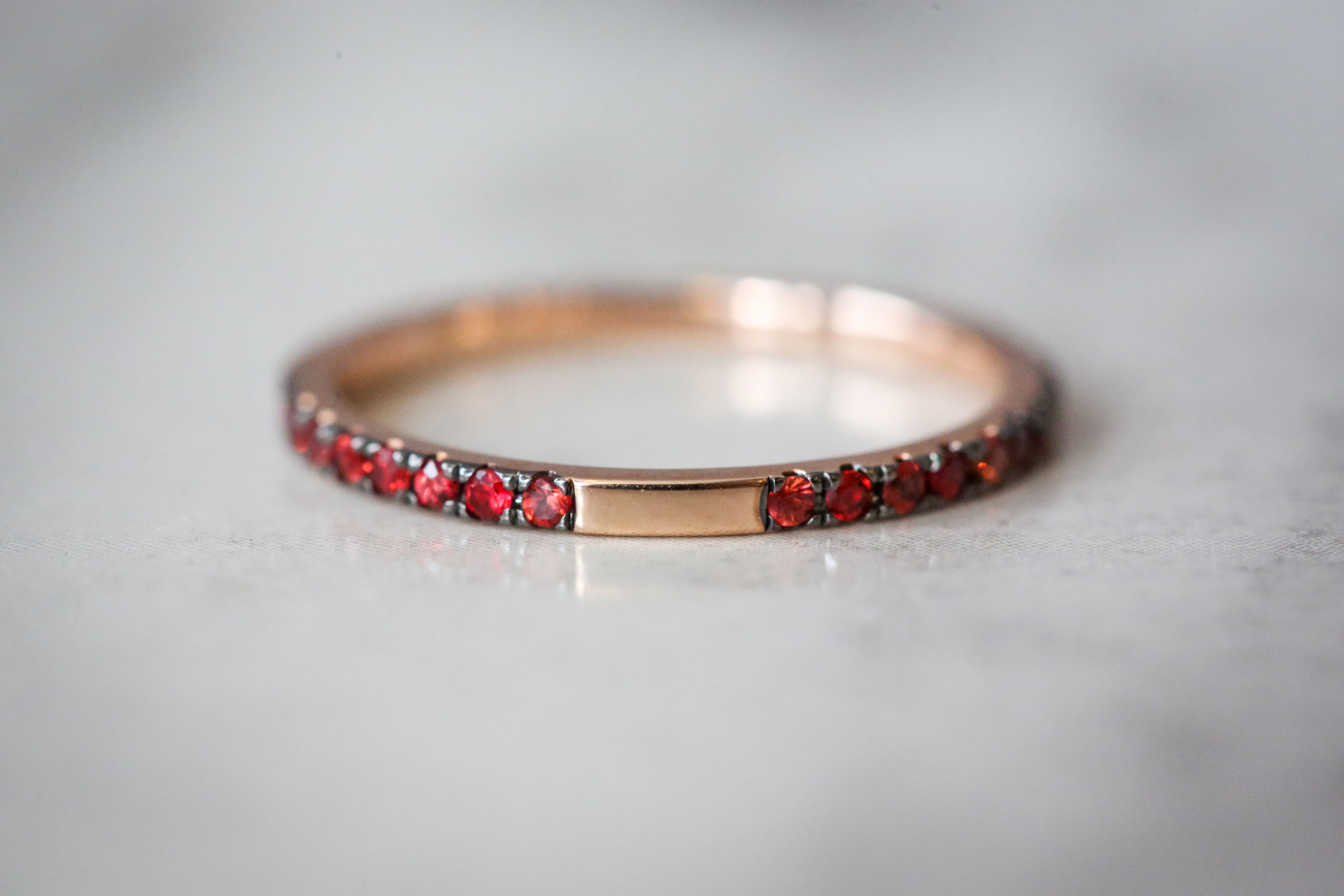 14k rose gold band with orange sapphires