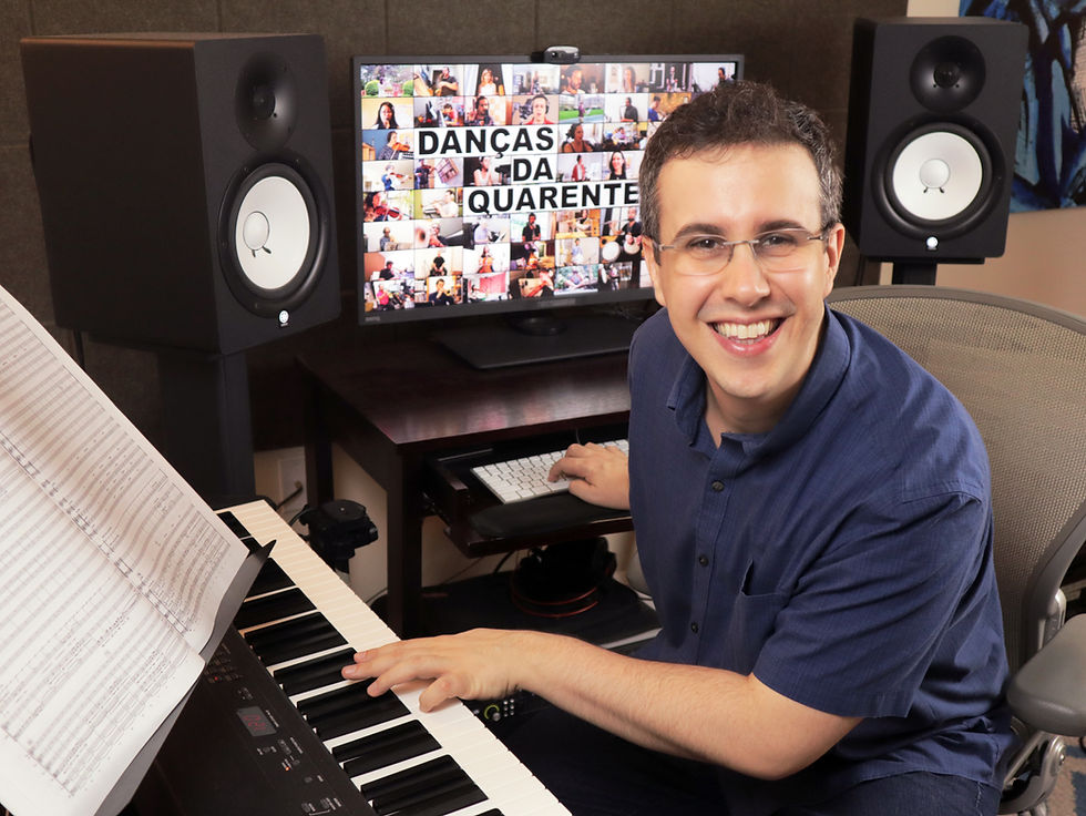 Composer and arranger Rafael Piccolotto de Lima working in his home studio surrounded by orchestral scores, piano, recording equipment, and music production tools.