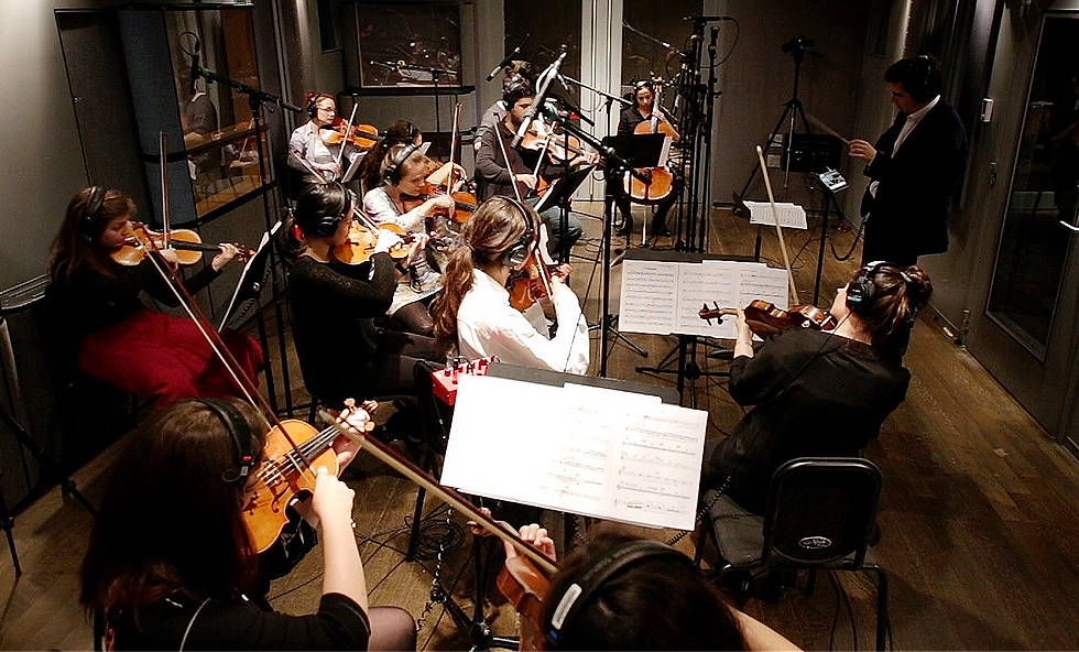 Rafael Piccolotto de Lima conducts a string ensemble of seven violins, three violas, and two cellos during the Chamber Project's first recording at New York University's James L. Dolan Studio in 2017.