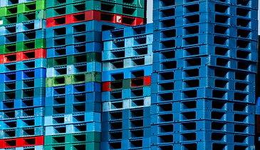 blue green red stacked plastic pallets
