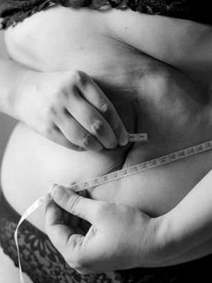 A person measuring their own waist