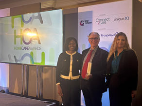 Sussex Grange home care professional Norbert Gutowski receives his award from Home Care Association Head of Membership Erica Siwo and is accompanied by Sussex Grange Home Care supervisor Maddie Horwood 