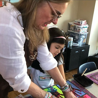 Volunteer helping a child with a project