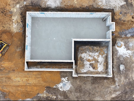 A clean, smooth, and professionally poured concrete basement floor in a South Jersey home, ready for the next stage of finishing.