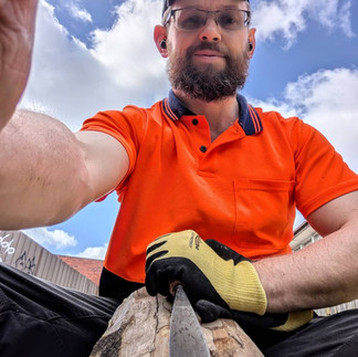 Michal sculpting from the perspective of the wood