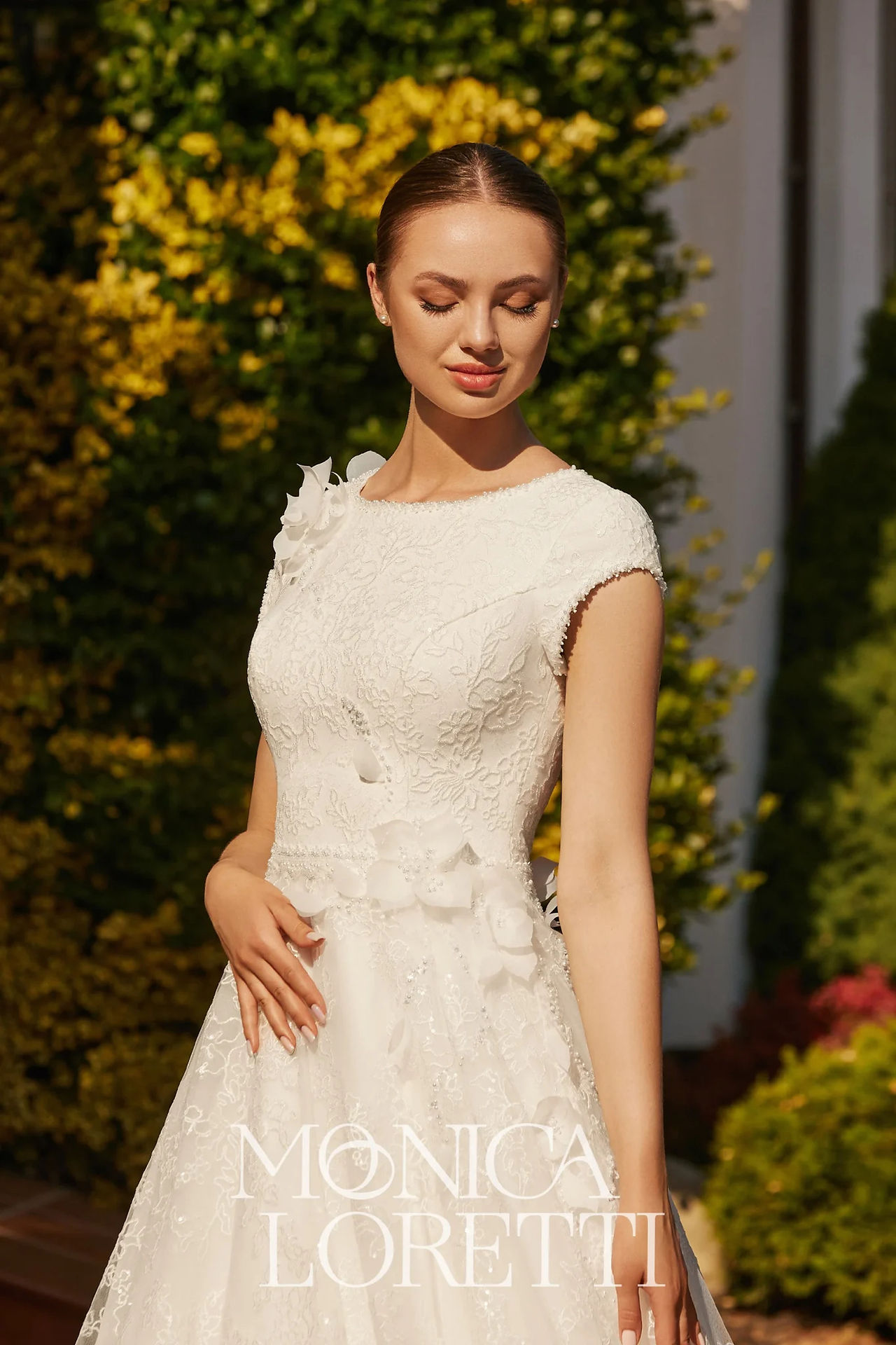 Ivory wedding dress with 3D flowers crossing the body