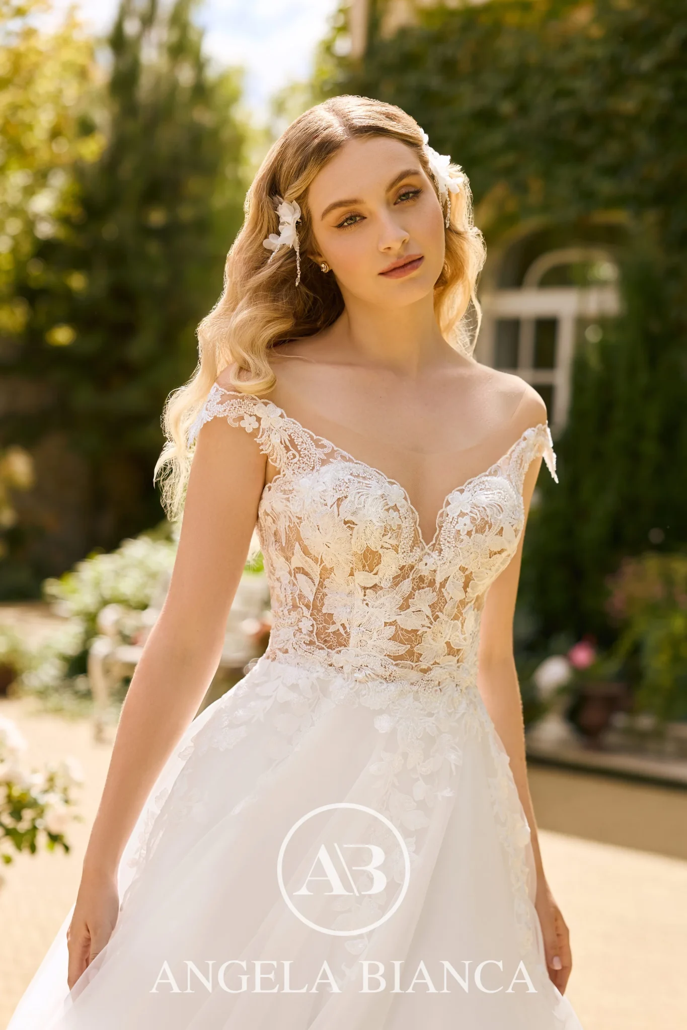 close up picture of model in a wedding dress featuring 3d flowers and lace applique