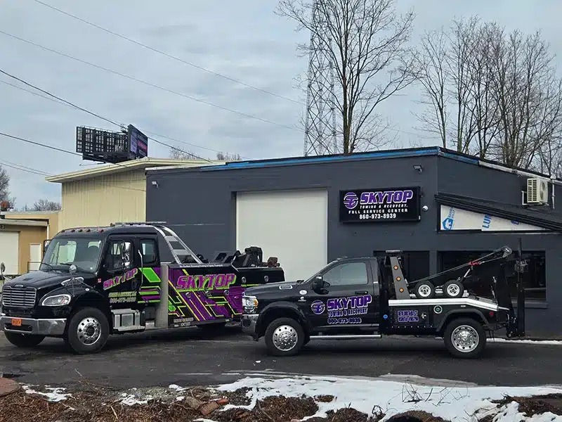 Skytop Towing & Recovery LLC tow trucks assisting vehicles on Connecticut highways and city roads while providing 24/7 towing and recovery services. Image includes light duty, medium duty, and heavy duty towing operations helping cars, SUVs, commercial vans, box trucks, and semi-trucks after breakdowns and accidents. Visual highlights emergency towing services CT, roadside assistance near me, flatbed towing services CT, truck towing company Connecticut, and a trusted towing company CT focused on safety, fast response, and reliable service statewide.