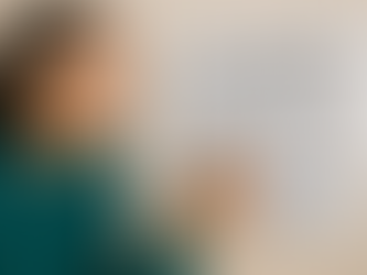 Smiling person in teal sweater marks a check on a Language Learning Habit Tracker. The board lists days of the week with multiple checks.