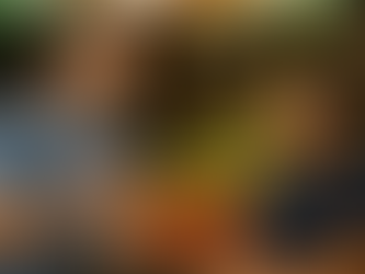 Two people smiling and chatting at a vibrant market with colorful produce like tomatoes, bananas, and limes in the background.