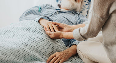 Elderly patient receiving compassionate in-home wound care with family support