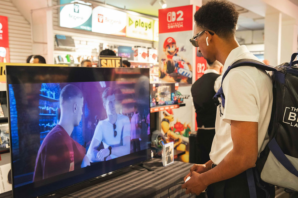 Man with backpack and earbuds watches a TV game demo in an electronics store, with SALE and Nintendo Switch signs.