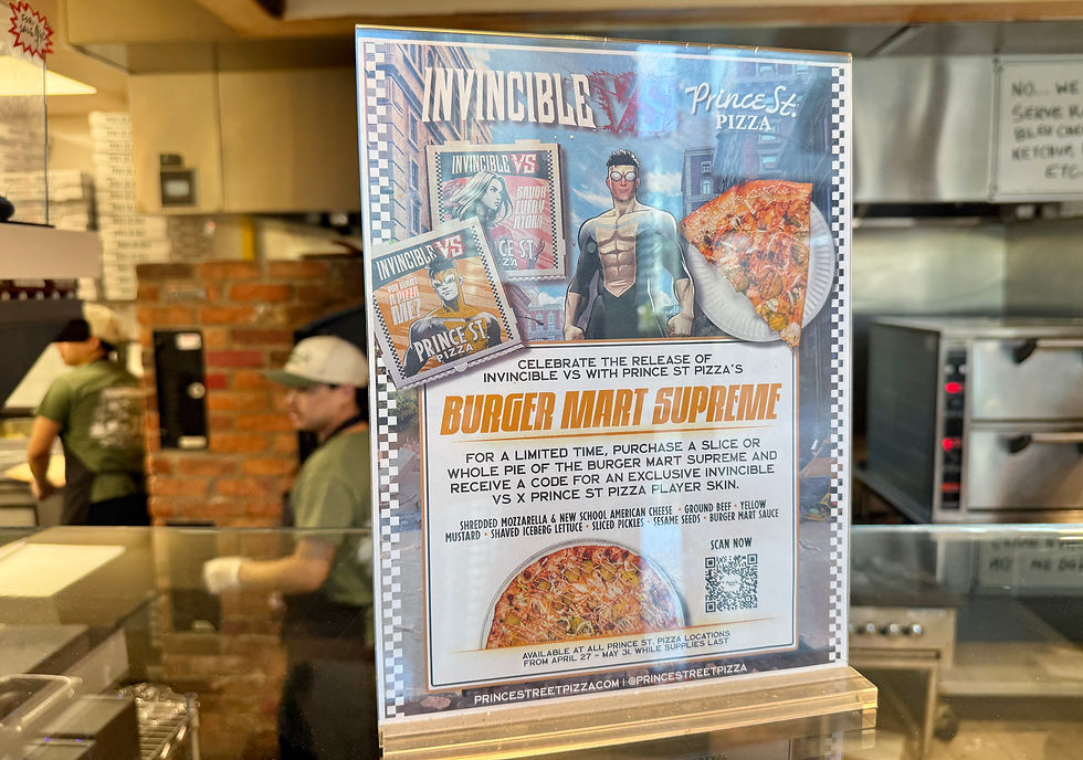 Poster in a pizza shop advertises Invincible vs Prince St Pizza Burger Mart Supreme, with staff and ovens behind glass.