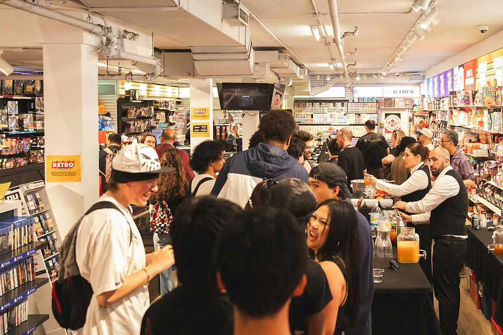 Crowded retro game store event with people chatting and browsing shelves under bright lights, with RETRO signs and drinks on a table