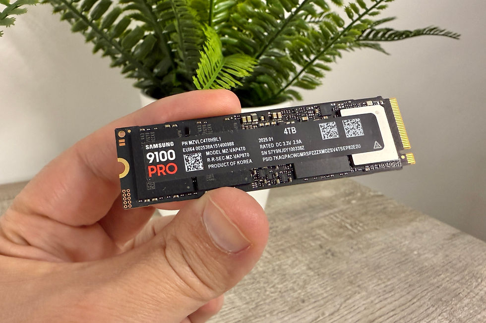 A hand holds a Samsung 9100 PRO 4TB SSD with detailed specs visible, set against a blurred plant background.