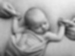 Sleeping newborn holding parents' fingers in a newborn photography session.