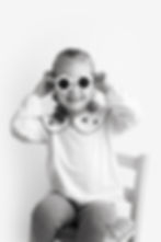 Smiling young girl in flower sunglasses from a newborn and family portfolio.