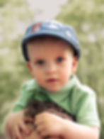 Toddler in a blue cap during newborn and family photography