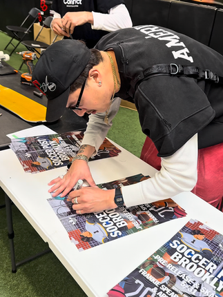 diego najera signing posters at the connect skateboarding make your own skateboard workshop at soccer post brooklyn for the pre release event of the thrasher x afa x adidas collection