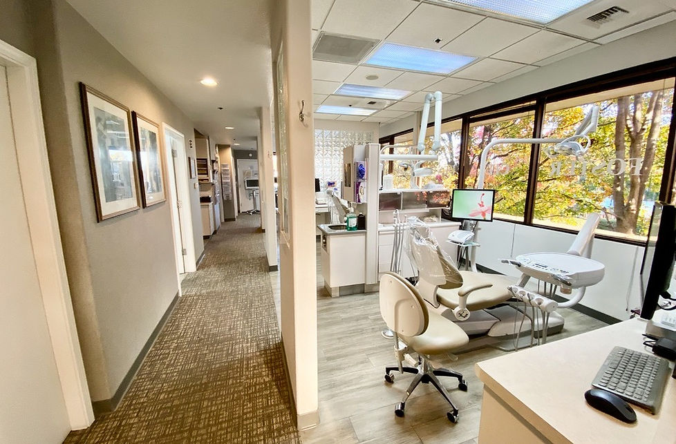 Image of Foster City Dental Care's large, modern, and clean office space featuring large windows and a nice view from the second floor looking onto a grove of trees.
