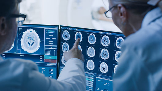 In Control Room Doctor and Radiologist Discuss Diagnosis while Watching Procedure and Moni