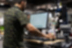 Employee checking out customer in retail area.