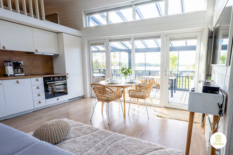 Kuva Villa Edenin valoisasta yhteistilasta, jossa olohuone ja keittiö sulautuvat yhtenäiseksi tilaksi.