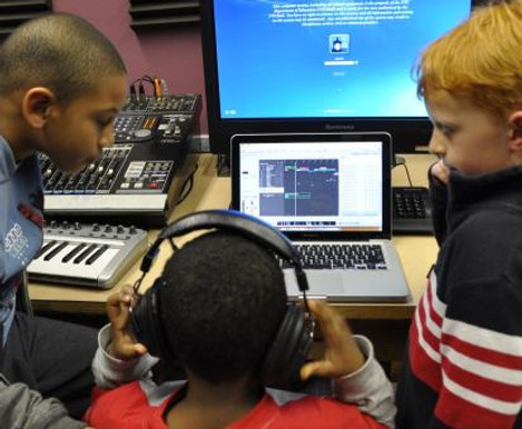 Kids participating in Music Production learning