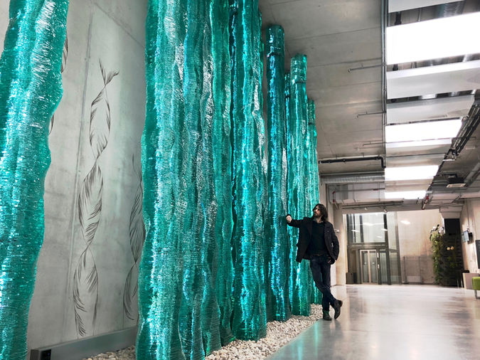 Architectural stacked glass sculpture IN NATURE (2015). Largest contemporary glass artwork in the Baltics. Glass in public space architecture at the Academic Center for Natural Sciences of the University of Latvia.