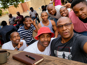 Author Dibi Jackson Monyepao smiling with his nephews during a family gathering in Tembisa, a moment of connection that inspired the reflection When the Pen Rests, The Soul Keeps Writing.